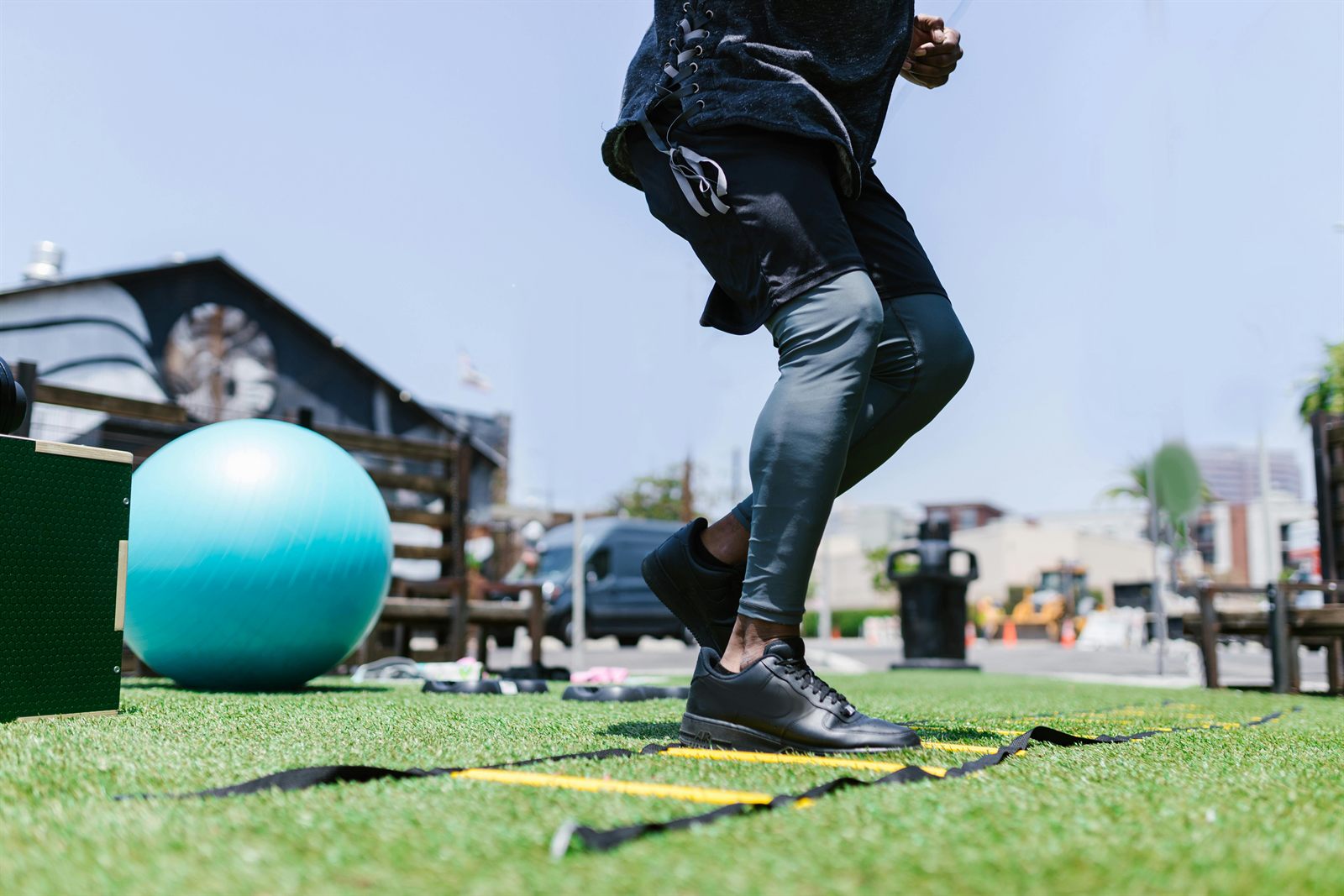 Sportif réalisant un exercice d'appuis sur une échelle d'agilité